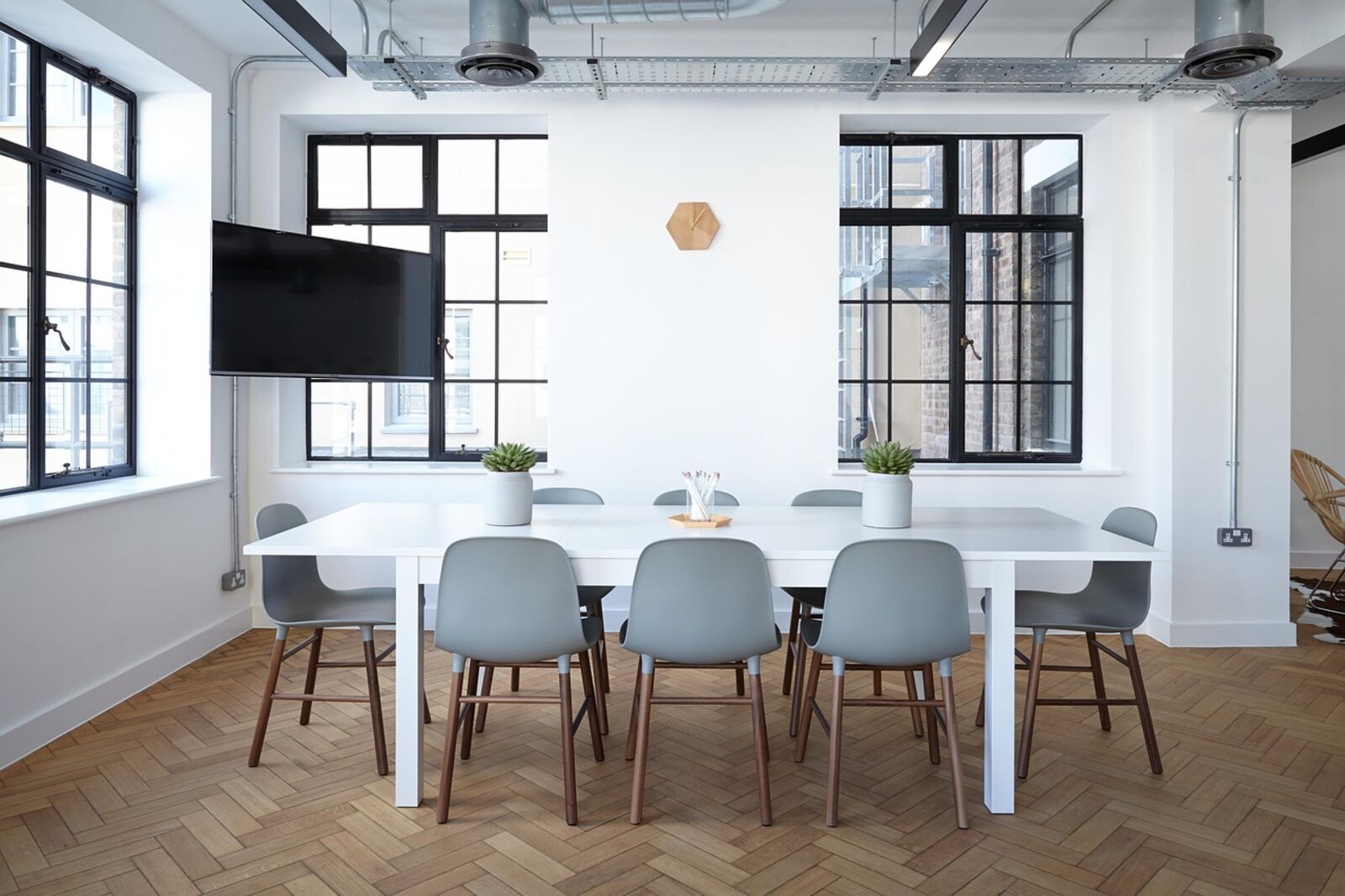 Bright, orderly boardroom with a long meeting table and natural light